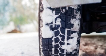 car tires on winter road covered with snow. vehicle on snowy all